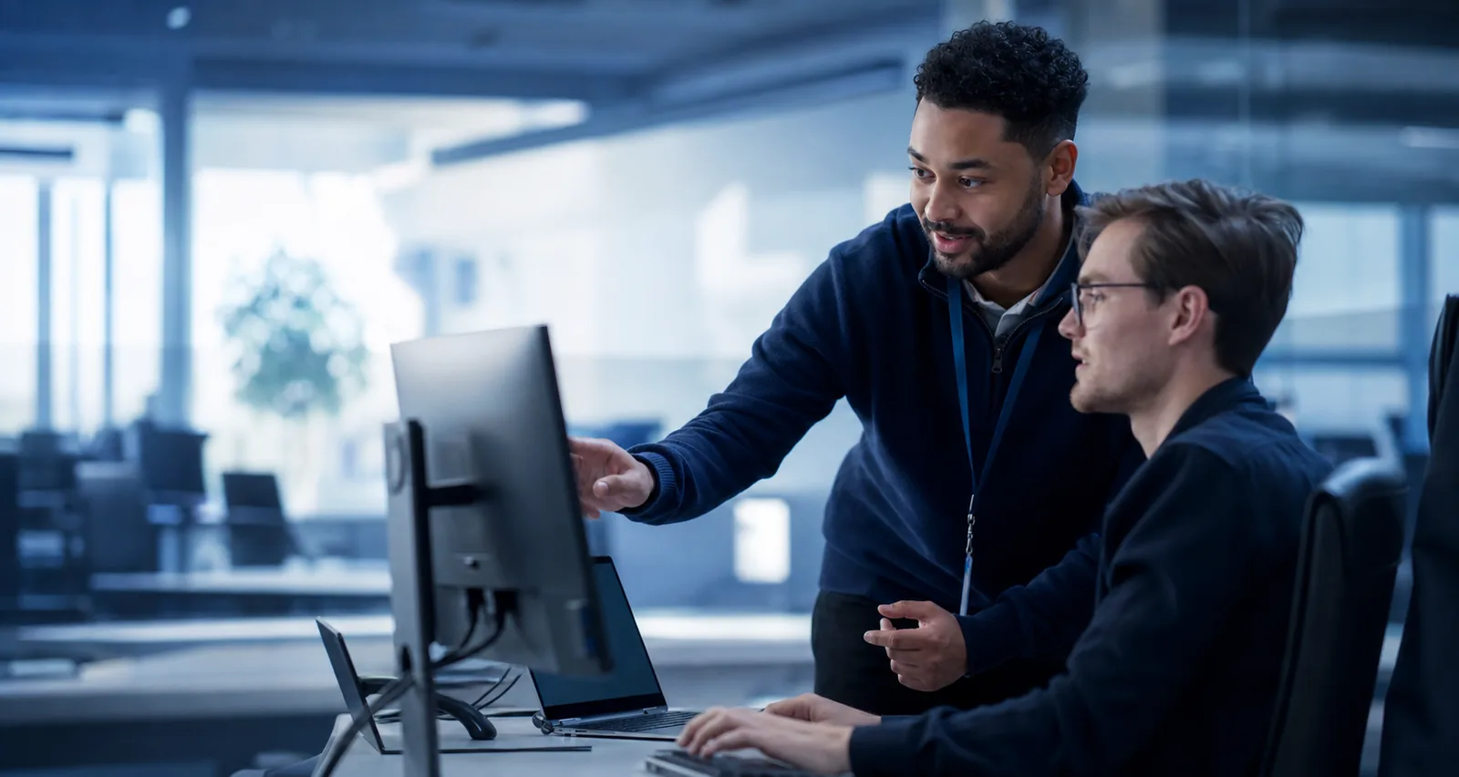 A Tech Savvy Solutions engineer helping a small business client at their desk