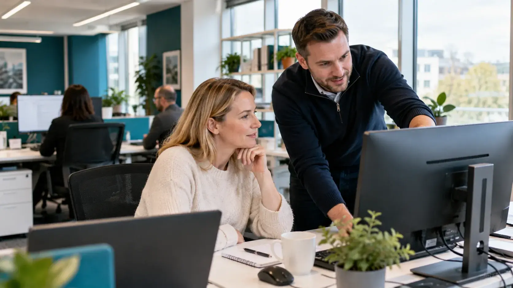 An IT support professional helping a small business client at their desk